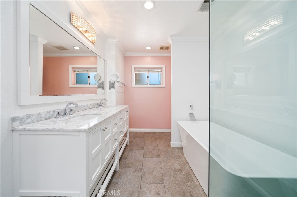 1721 East Ruddock Street Covina, CA 91724 - Photo 16 of 39 a bathroom with a granite countertop double vanity sink a mirror and a shower