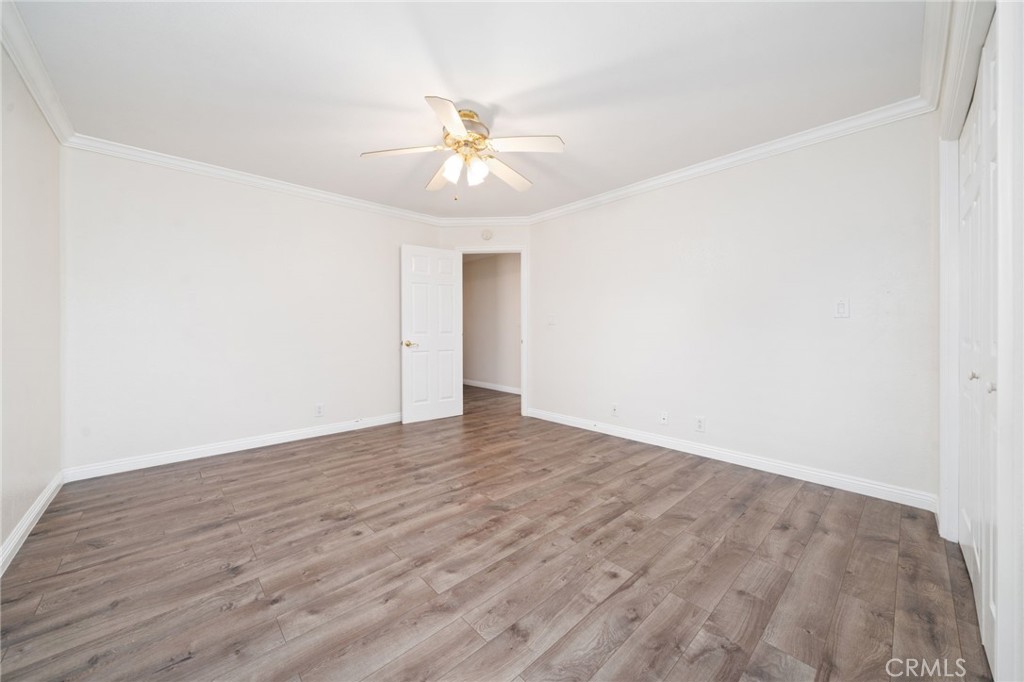 1721 East Ruddock Street Covina, CA 91724 - Photo 20 of 39 an empty room with wooden floor and fan