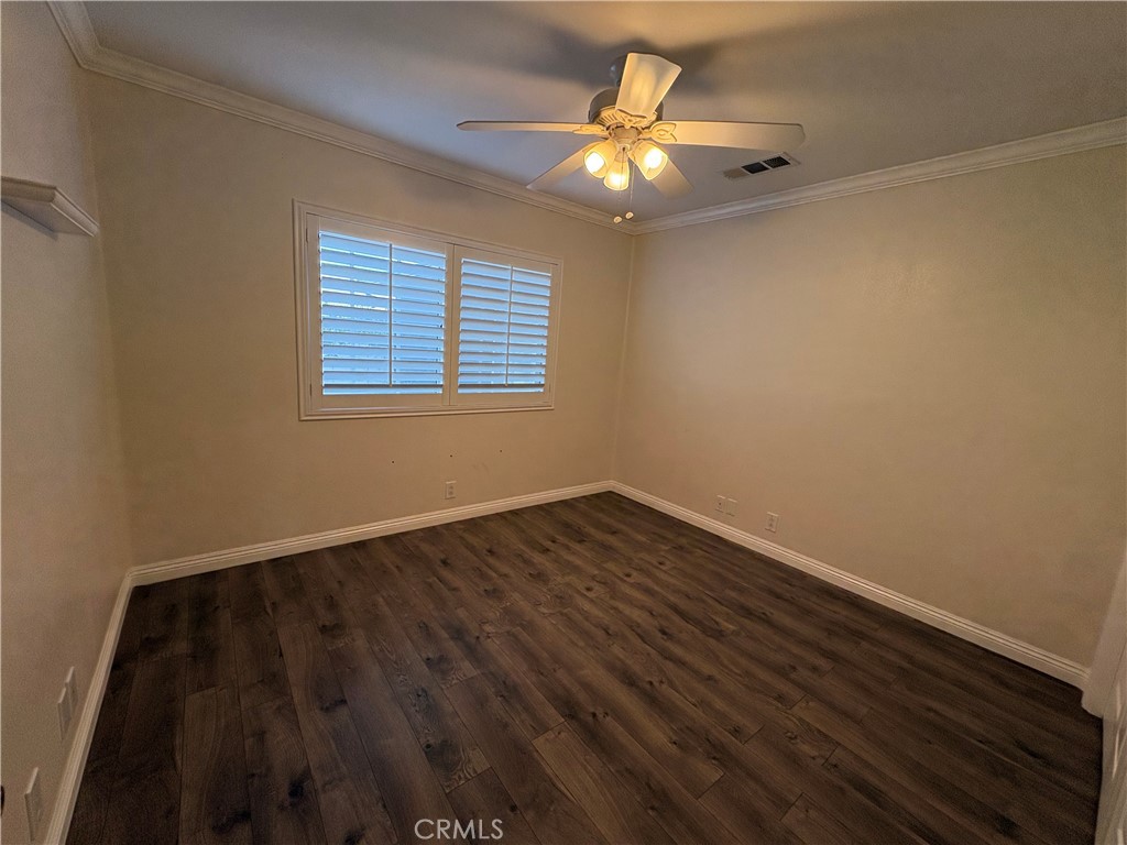 1721 East Ruddock Street Covina, CA 91724 - Photo 21 of 29 a view of an empty room with wooden floor and a window
