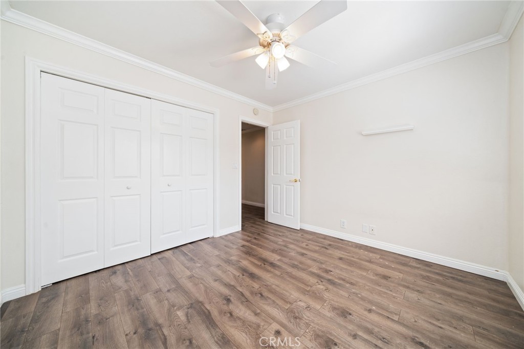 1721 East Ruddock Street Covina, CA 91724 - Photo 22 of 39 an empty room with wooden floor and a ceiling fan