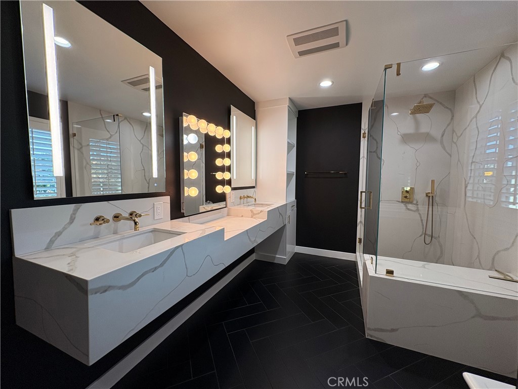 1721 East Ruddock Street Covina, CA 91724 - Photo 26 of 29 a bathroom with a double vanity sink a mirror and a shower