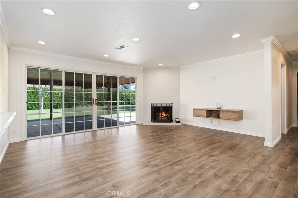 1721 East Ruddock Street Covina, CA 91724 - Photo 6 of 39 a view of empty room with wooden floor and fireplace