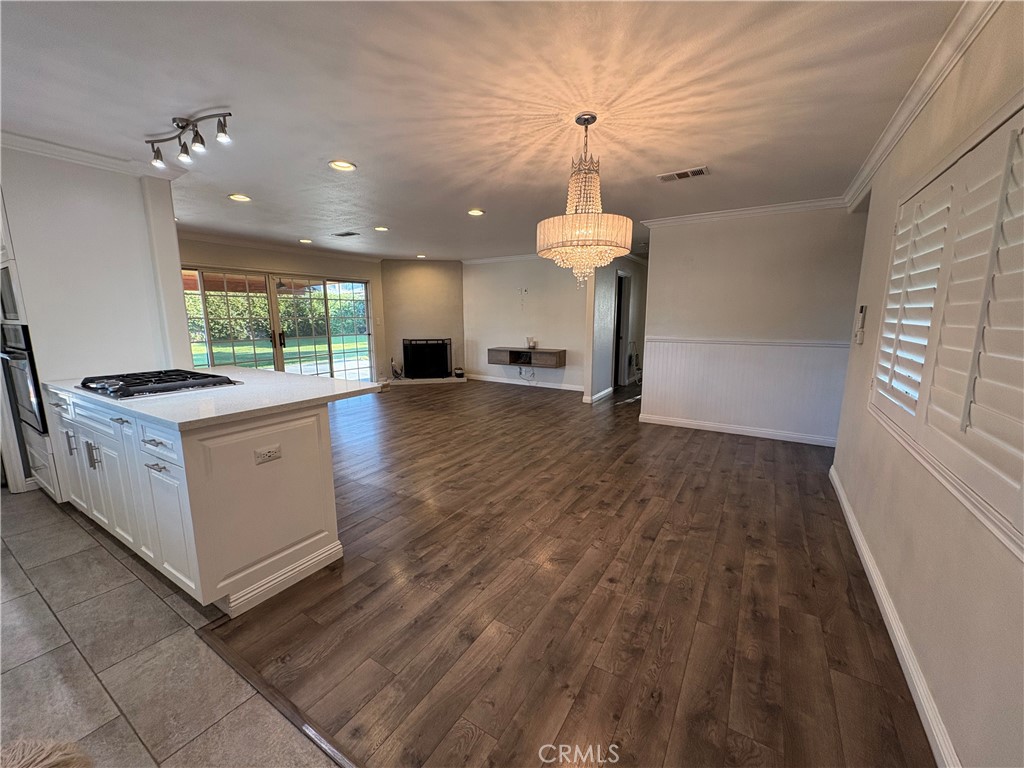 1721 East Ruddock Street Covina, CA 91724 - Photo 9 of 29 a view of a kitchen with a stove cabinets and a wooden floor