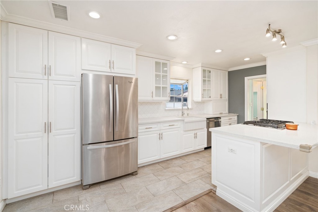 1721 East Ruddock Street Covina, CA 91724 - Photo 10 of 39 a kitchen with a refrigerator sink and cabinets