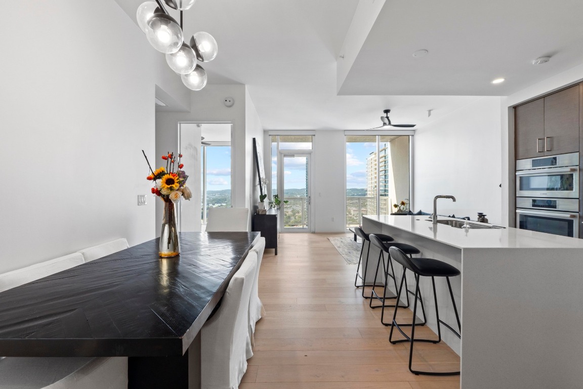 301 West Avenue, Unit 2708 Austin, TX 78701 - Photo 2 of 27 a view of a dining room and livingroom with furniture wooden floor a chandelier