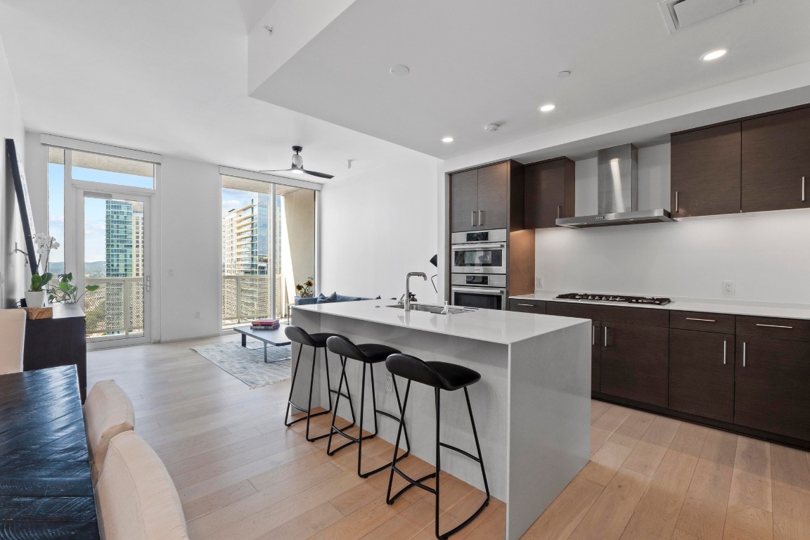301 West Avenue, Unit 2708 Austin, TX 78701 - Photo 3 of 27 a kitchen with stainless steel appliances kitchen island granite countertop a sink and cabinets