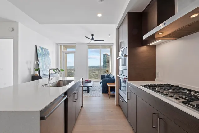 a kitchen with stove a sink and cabinets