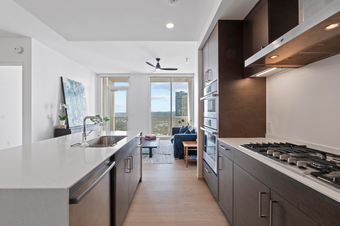 301 West Avenue, Unit 2708 Austin, TX 78701 - Photo 5 of 27 a kitchen with stove a sink and cabinets