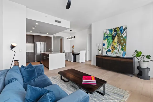 a living room with furniture and kitchen view