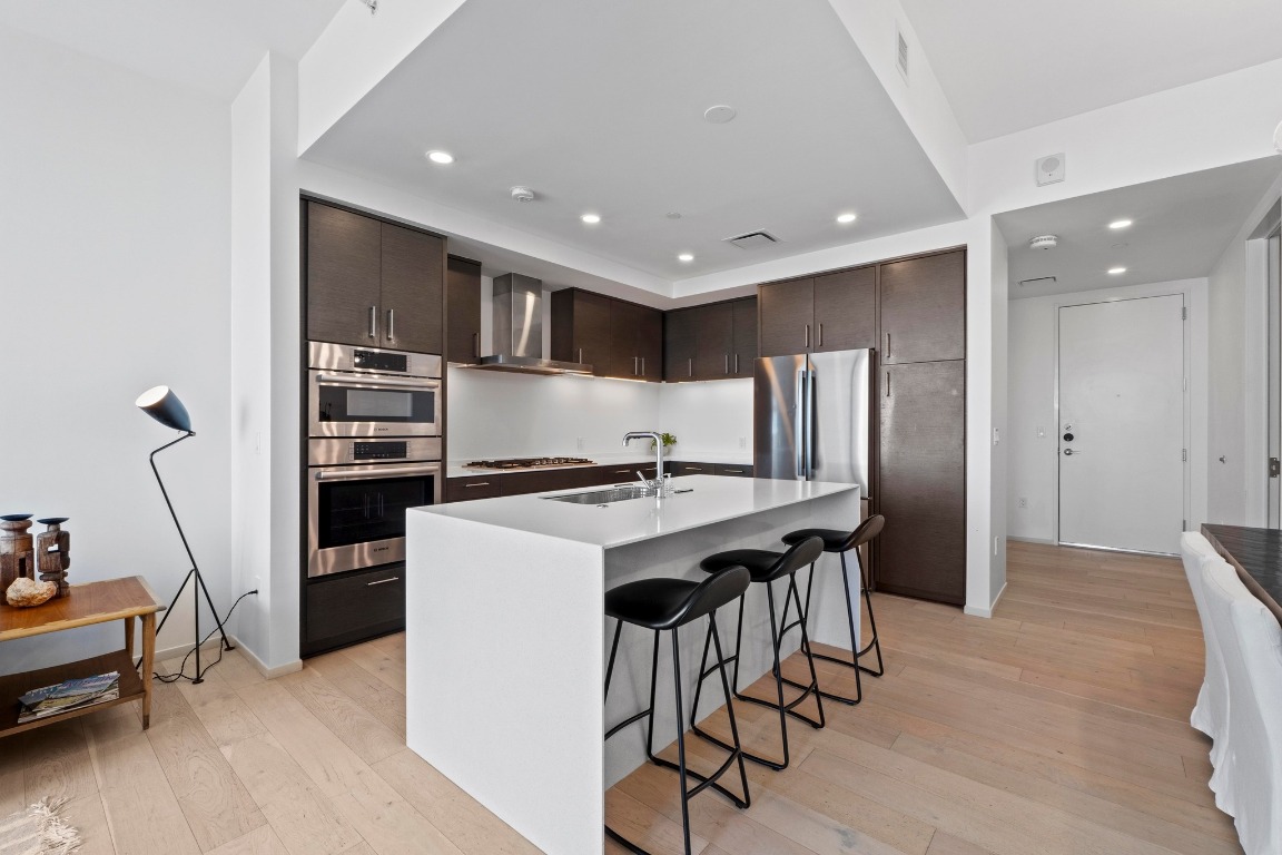 301 West Avenue, Unit 2708 Austin, TX 78701 - Photo 10 of 27 a kitchen with stainless steel appliances kitchen island granite countertop a refrigerator and a stove top oven