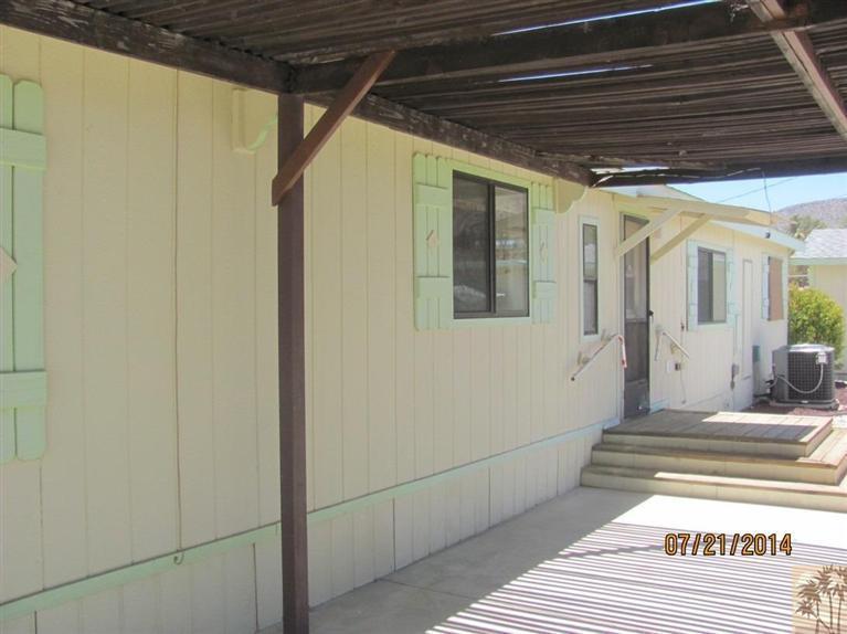 7180 Saddleback Road Joshua Tree, CA 92252 - Photo 20 of 20 a view of a hallway with wooden floor and a bathroom