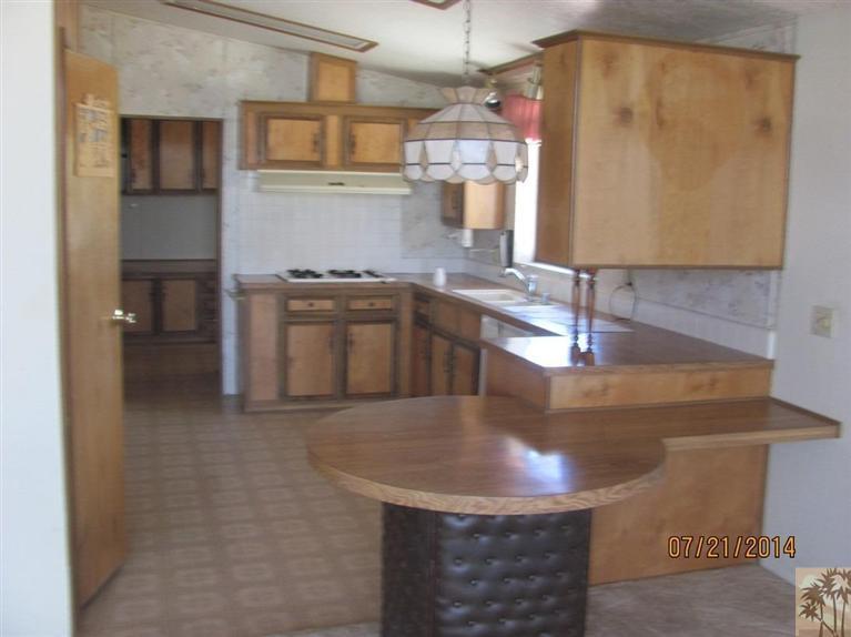 7180 Saddleback Road Joshua Tree, CA 92252 - Photo 8 of 20 a kitchen with stainless steel appliances granite countertop a sink and a stove