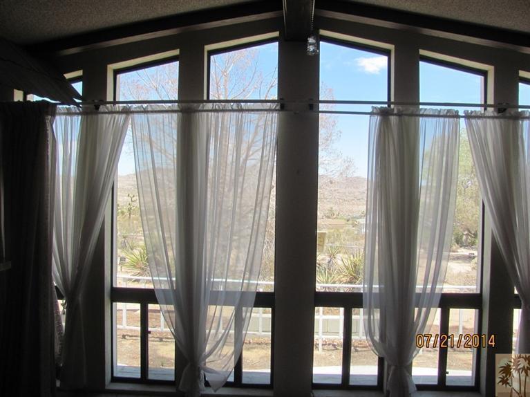7180 Saddleback Road Joshua Tree, CA 92252 - Photo 9 of 20 a front view of a glass door with a glass door