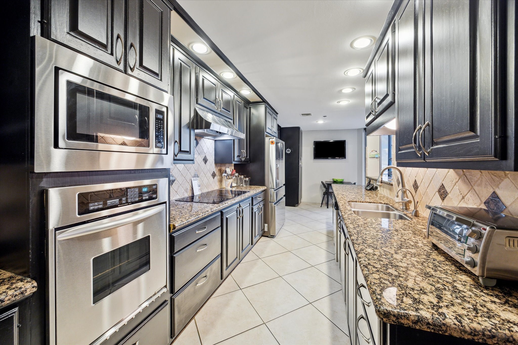 3350 McCue Road, Unit 1504 Houston, TX 77056 - Photo 10 of 32 The kitchen includes generous cabinetry for storage and a cozy breakfast area.