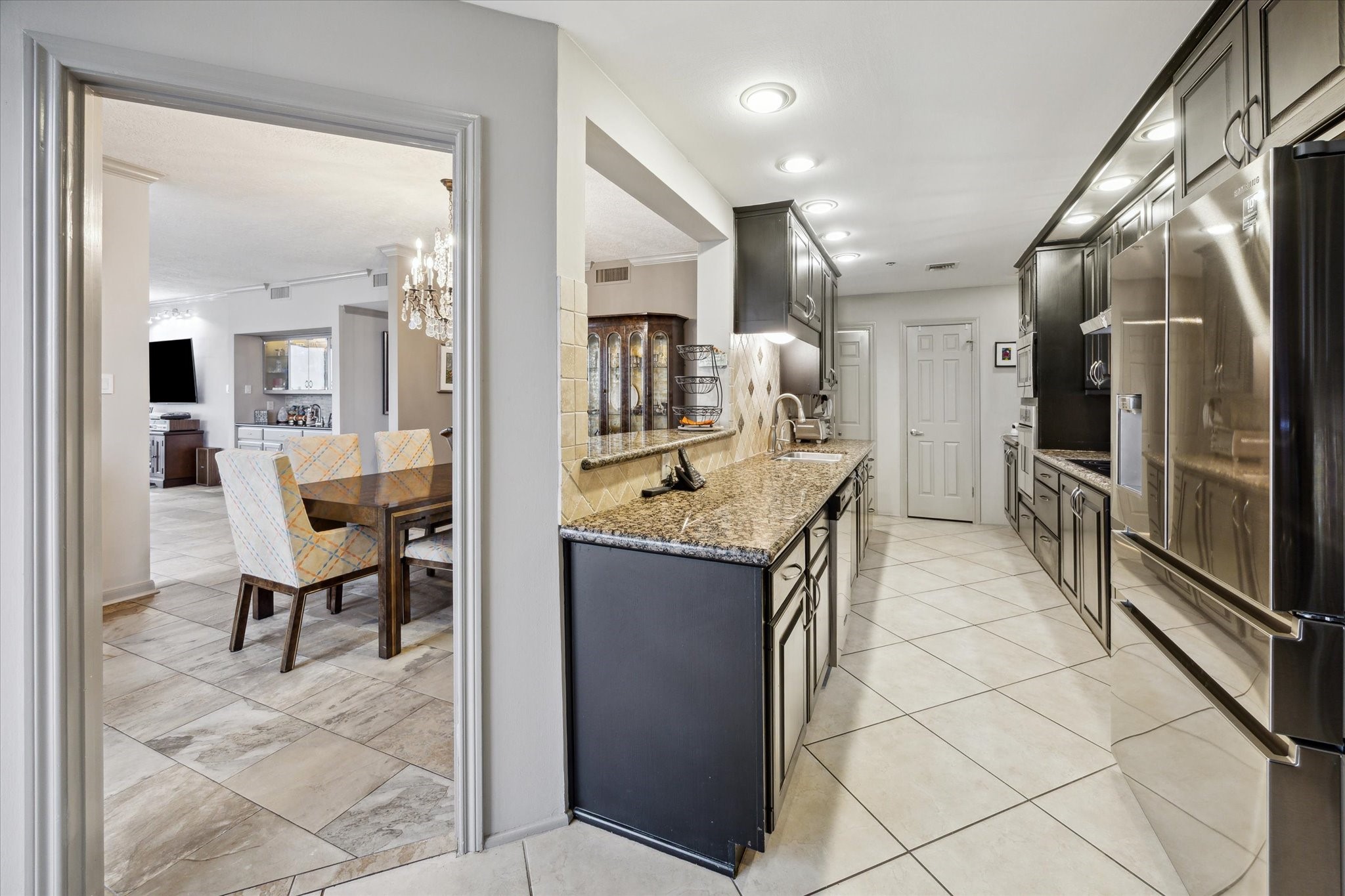 3350 McCue Road, Unit 1504 Houston, TX 77056 - Photo 13 of 32 This view highlights the seamless transition from the kitchen into the dining room, with a window that opens up the space and enhances the flow.