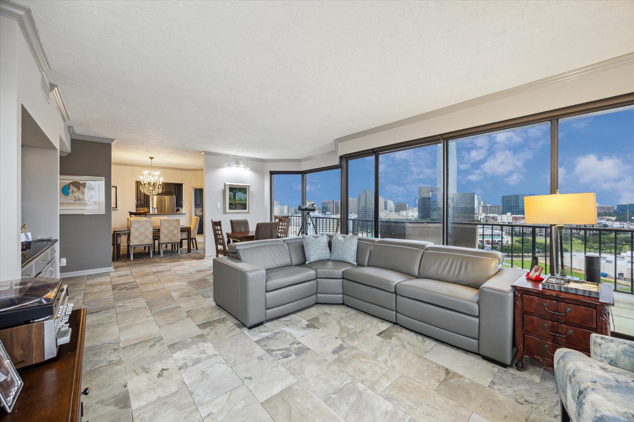 3350 McCue Road, Unit 1504 Houston, TX 77056 - Photo 6 of 32 The elongated living room provides space for a comfortable seating area and additional furnishings such as a breakfast or game table, offering versatile options for daily living and entertaining. It also includes a stylish wet bar for added convenience.