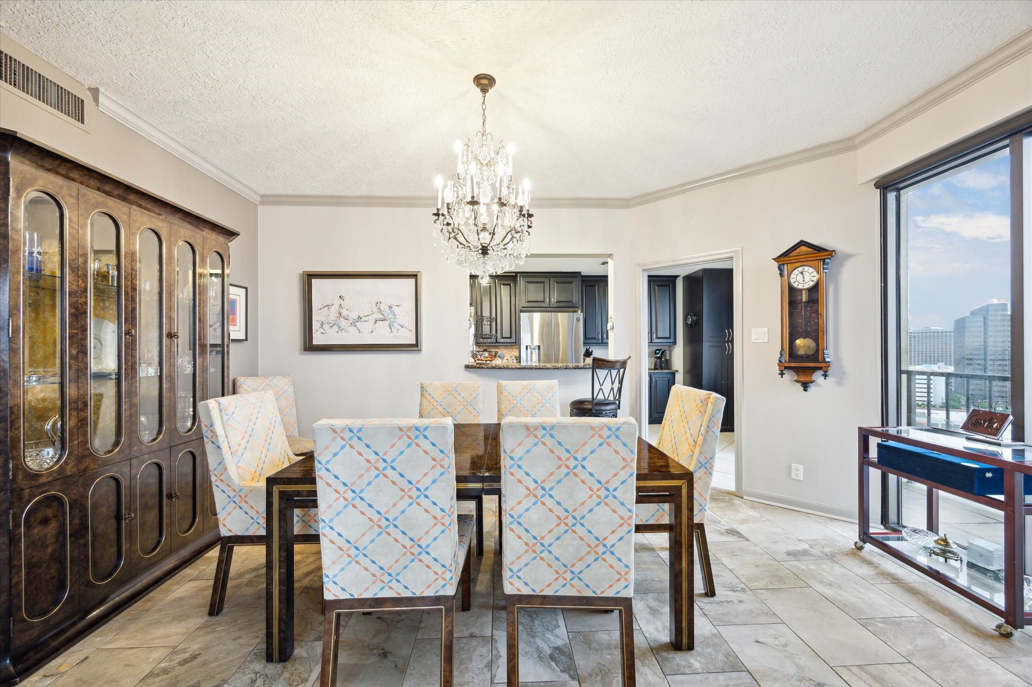 3350 McCue Road, Unit 1504 Houston, TX 77056 - Photo 8 of 32 The dining room, situated just off the kitchen, flows seamlessly into the living room and features crown molding, and a large window that continues the panoramic view of town.