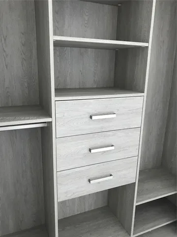 a view of empty room with floor to ceiling window