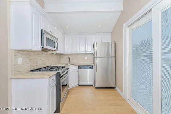 a kitchen with a refrigerator stove and microwave