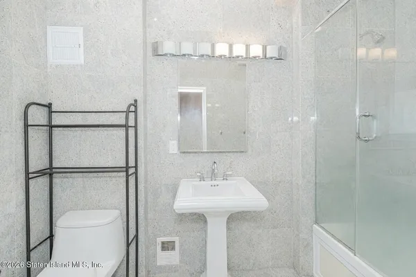 a bathroom with a sink toilet and shower