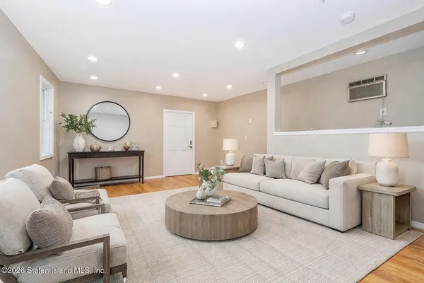 a living room with furniture a fireplace and a table