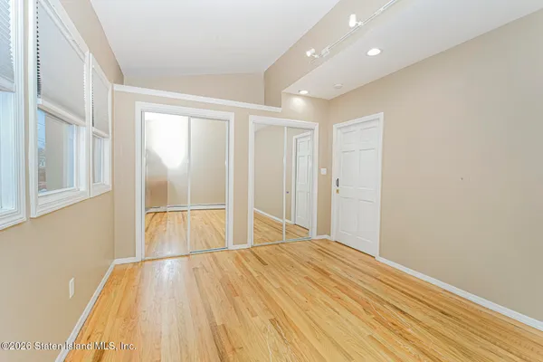 a view of a room with wooden floor and natural light