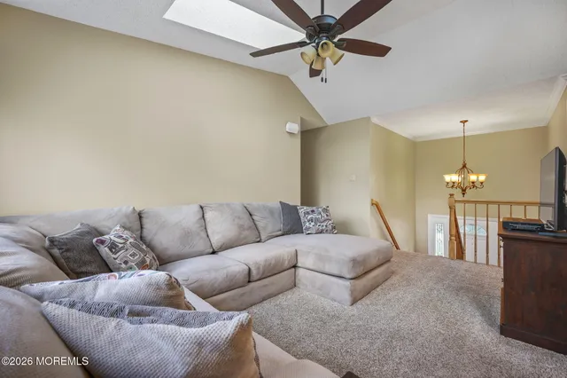 a living room with furniture and a chandelier
