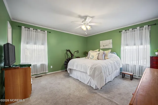 a spacious bedroom with a bed and a chandelier