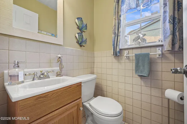 a bathroom with a sink toilet and mirror