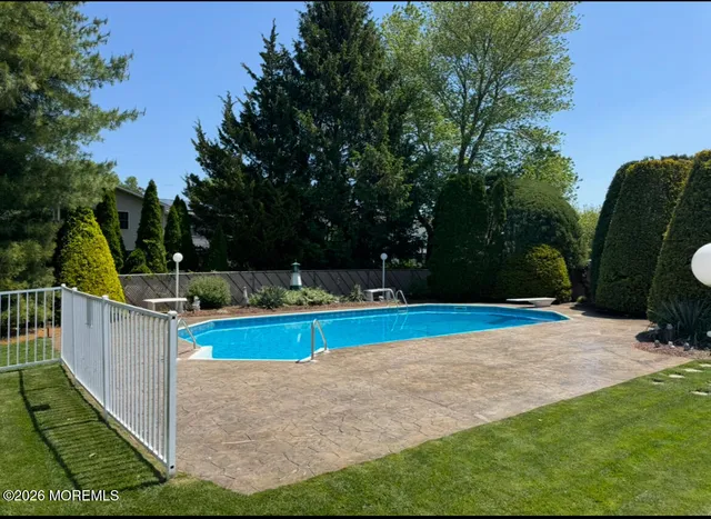 a view of a backyard with swimming pool