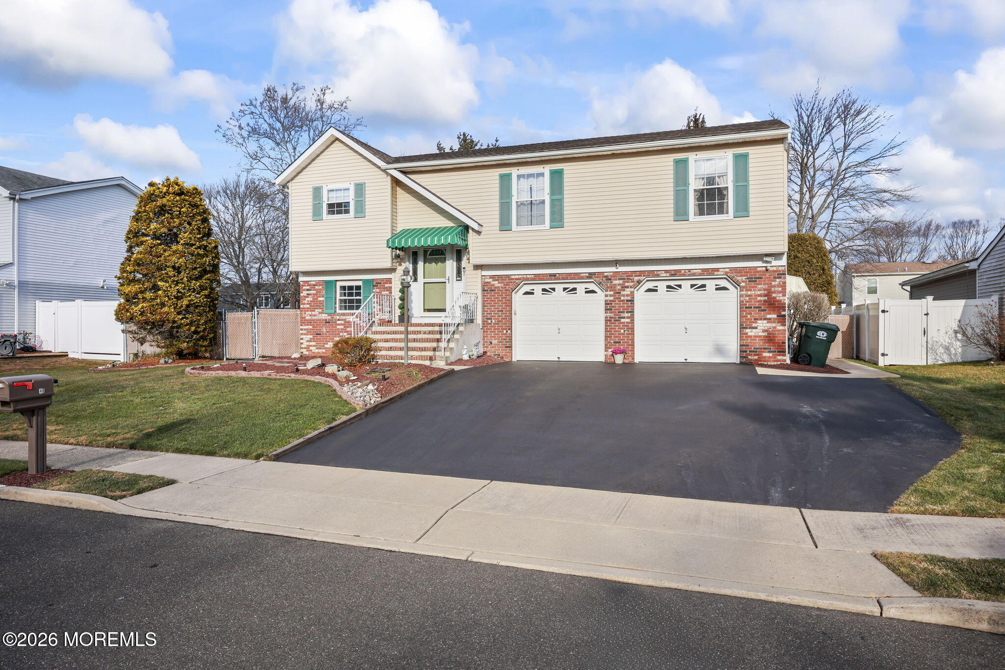 48 Hedgewood Road Howell, NJ 07731 - Photo 5 of 46 a front view of a house with a yard and garage