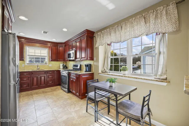 a kitchen with a stove a sink and a refrigerator