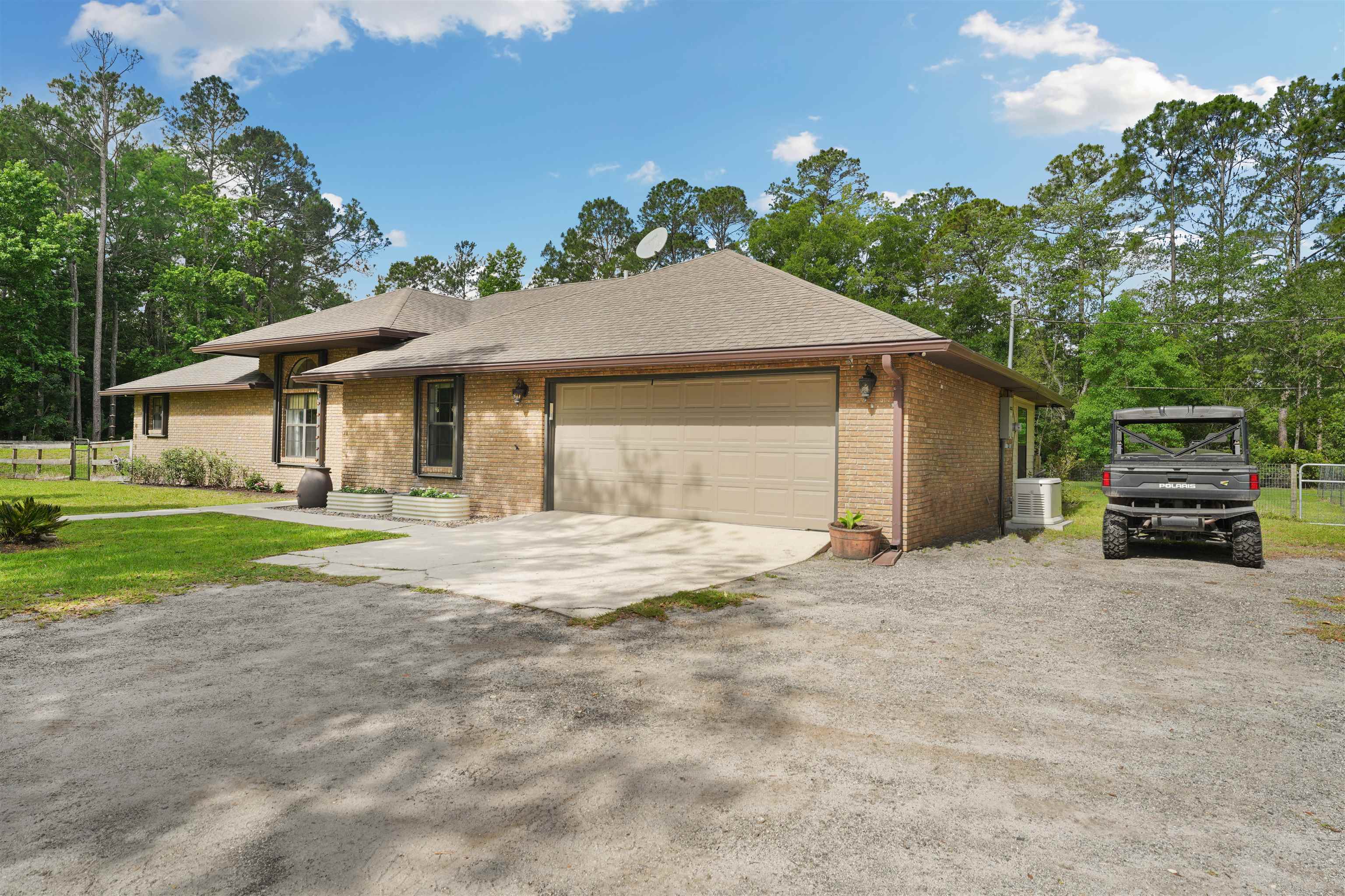 1805 Bennett Road St. Augustine, FL 32092 - Photo 5 of 65 a front view of a house with a yard and garage