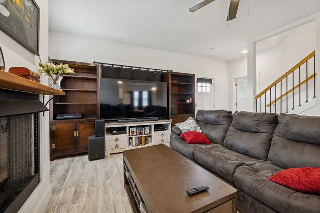 a kitchen with stainless steel appliances granite countertop a refrigerator a stove top oven a sink dishwasher and a oven with wooden floor