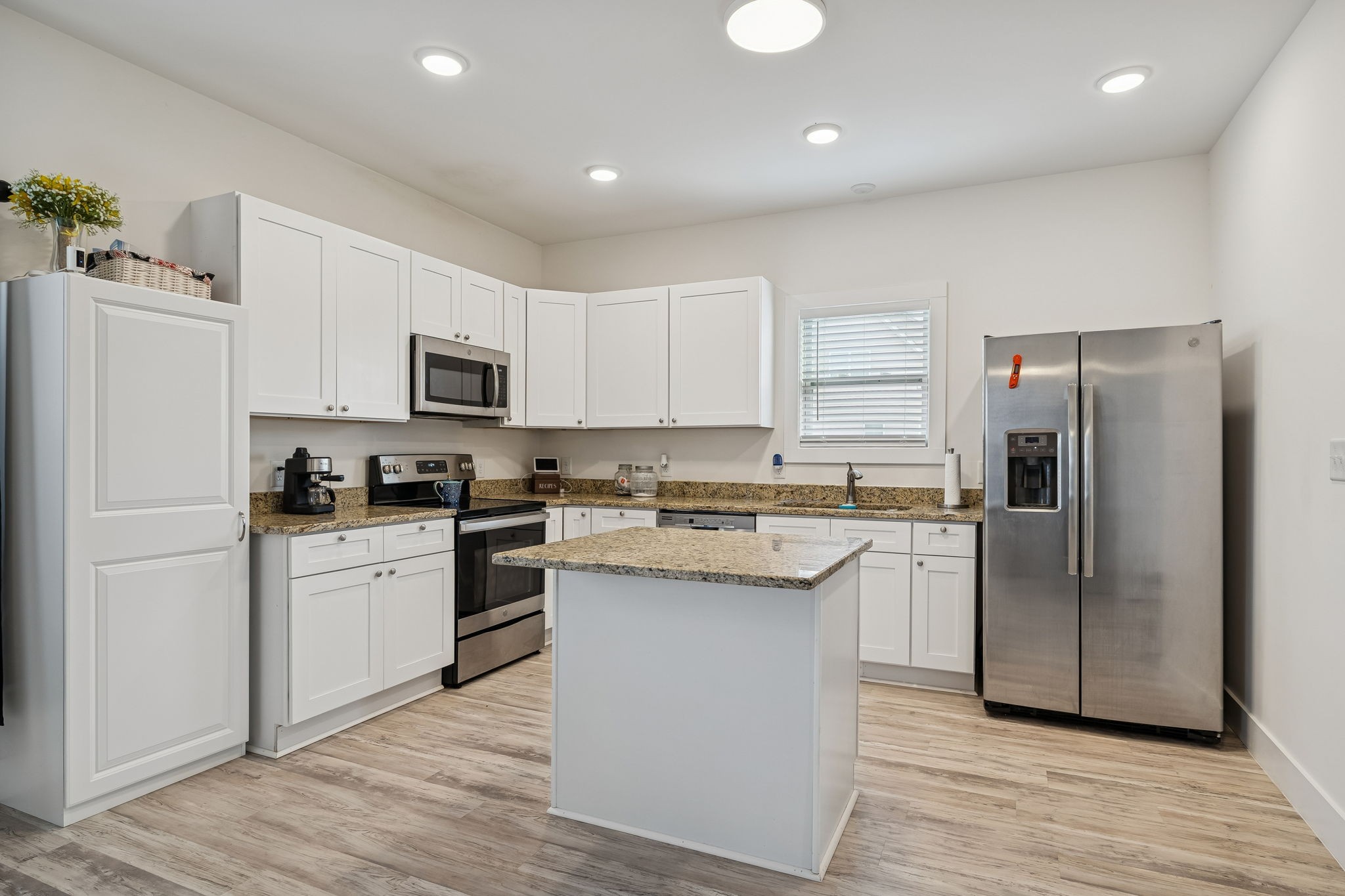 137 Mt Vernon Church Road Bethpage, TN 37022 - Photo 18 of 44 a kitchen with white cabinets and stainless steel appliances