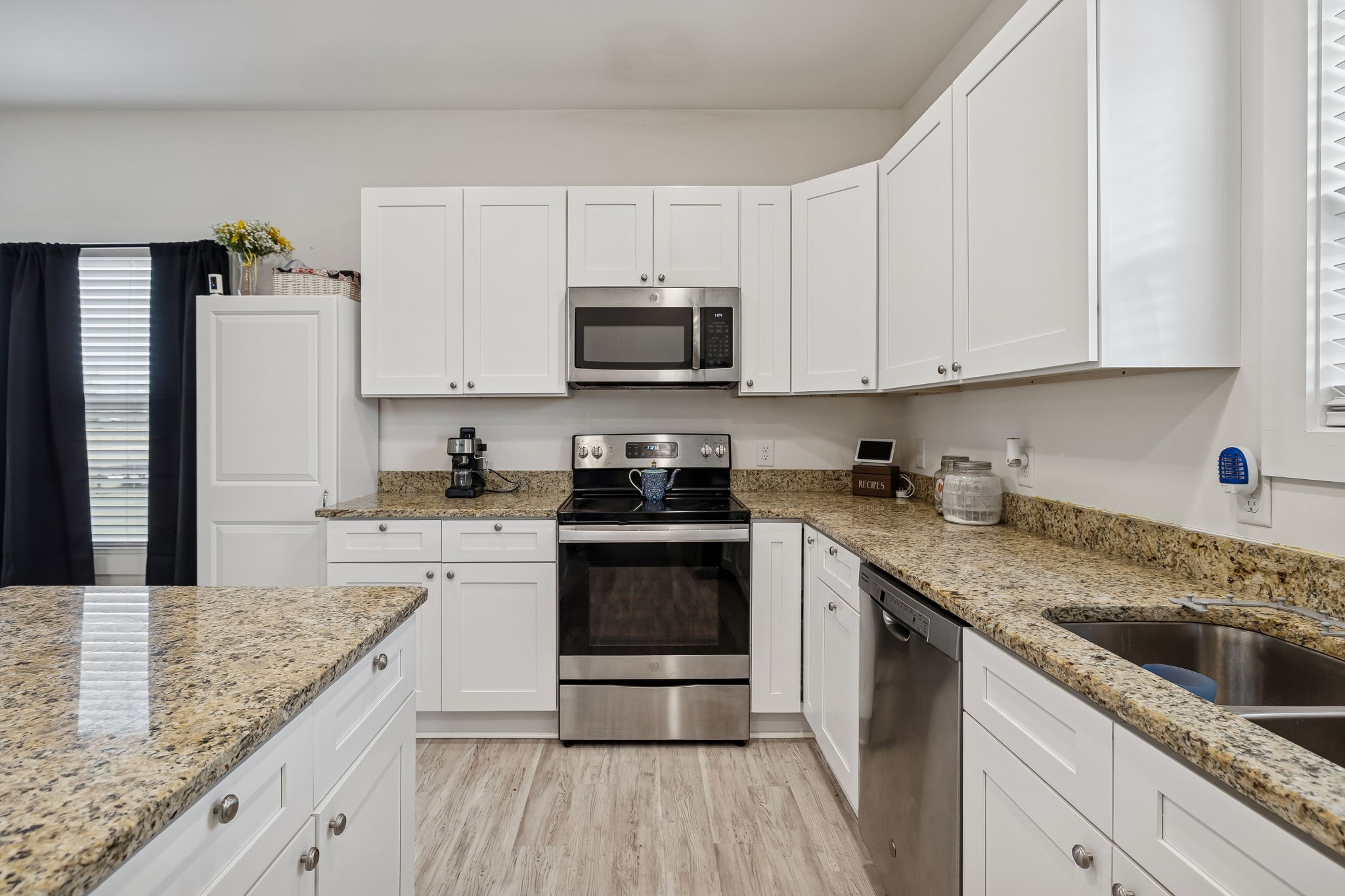 137 Mt Vernon Church Road Bethpage, TN 37022 - Photo 21 of 44 a kitchen with granite countertop a sink dishwasher a stove and a refrigerator with wooden floor