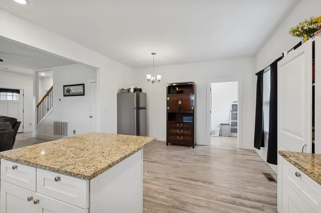 a view of an empty room with closet and a window