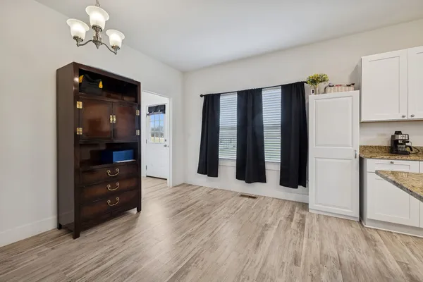 a view of kitchen with stainless steel appliances refrigerator oven microwave and furniture