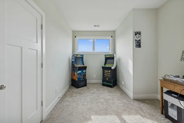 a view of a workspace with furniture and a window