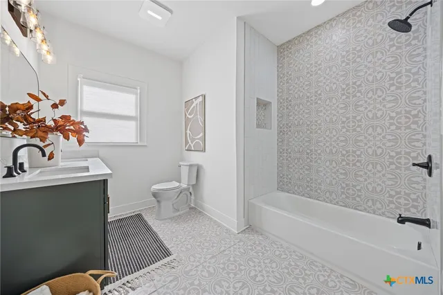 a bathroom with a sink mirror and vanity