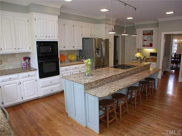 10769 Trego Trail Raleigh, NC 27614 - Photo 8 of 25 Simple stunning kitchen with granite countertops, large breakfast bar, hardwood floors, updated lighting, and skylights. Kitchen