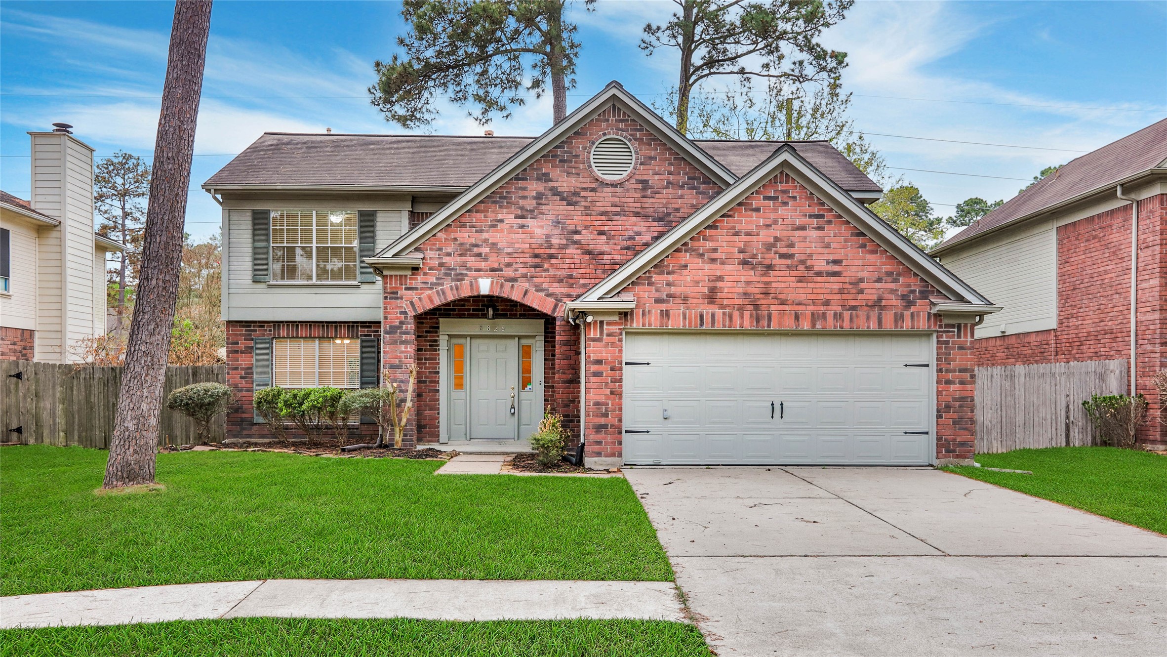 8826 Sunny Point Drive Spring, TX 77379 - Photo 2 of 16 a front view of a house with a garden and plants