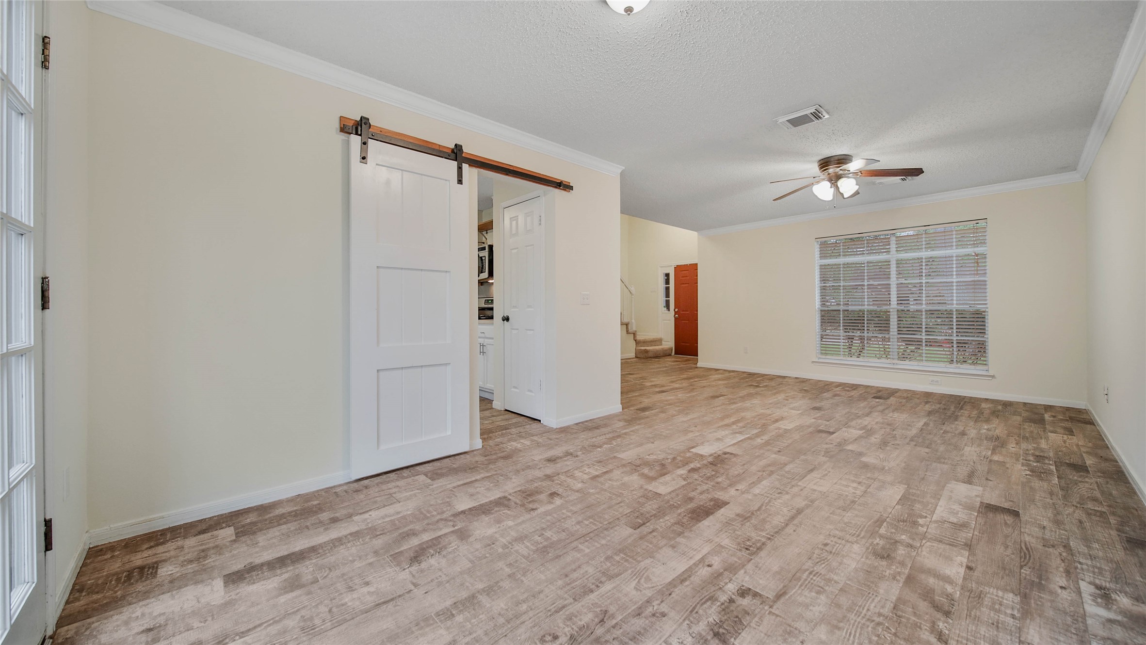 8826 Sunny Point Drive Spring, TX 77379 - Photo 9 of 16 a view of empty room with wooden floor and fan