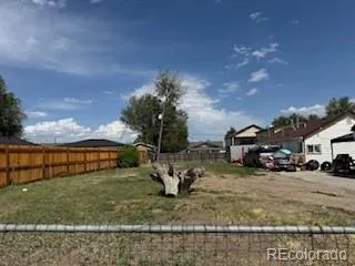 a view of a yard with cars