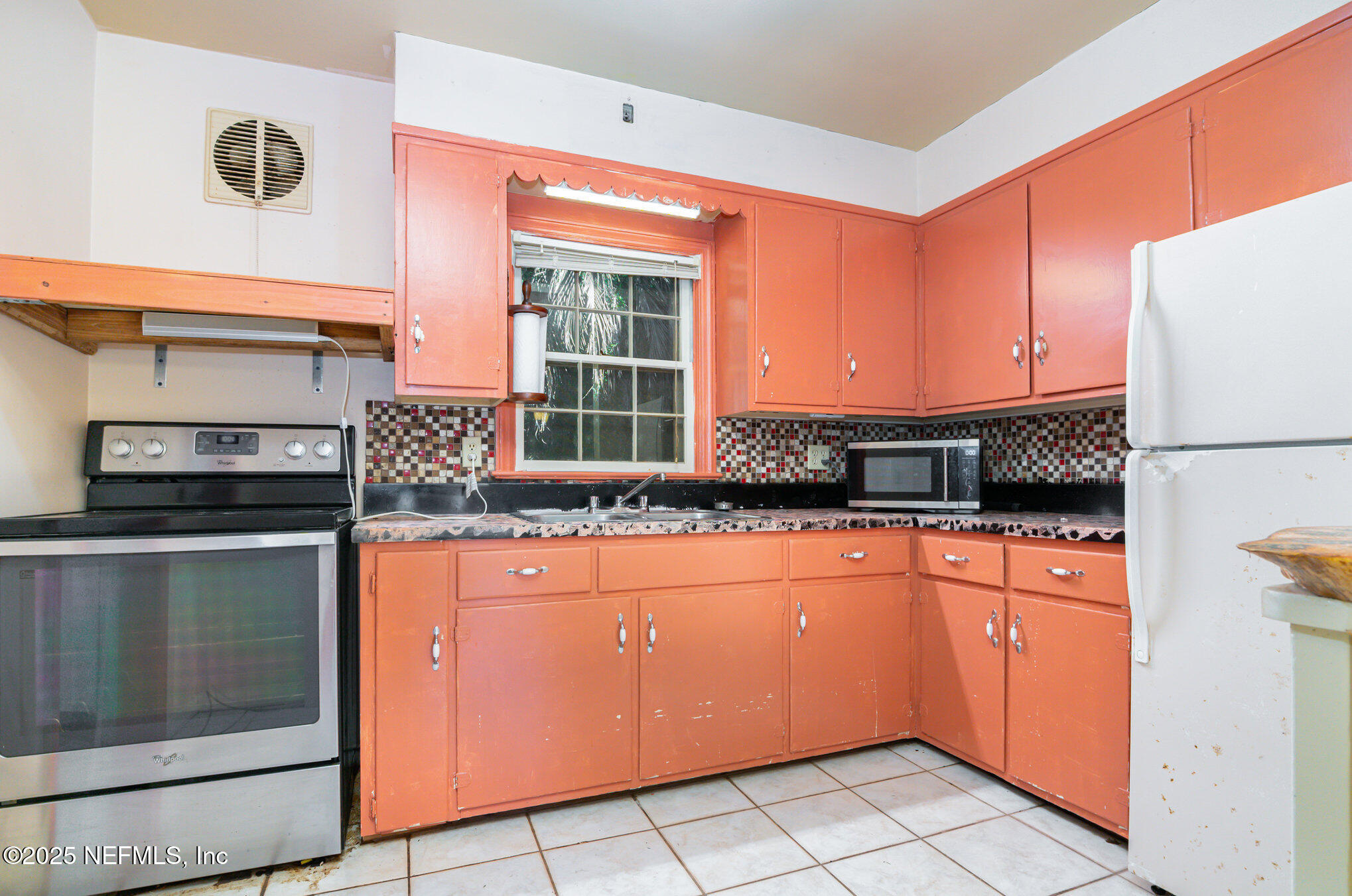 7838 State Road 21 Keystone Heights, FL 32656 - Photo 12 of 22 a kitchen with stainless steel appliances granite countertop a stove a sink and a refrigerator