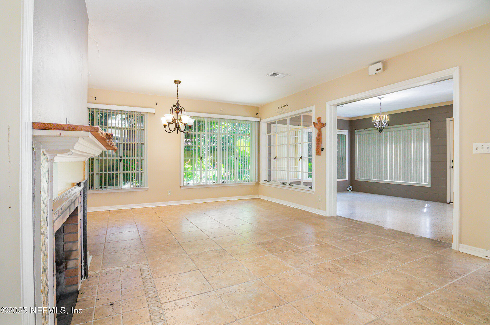 7838 State Road 21 Keystone Heights, FL 32656 - Photo 4 of 22 an empty room with fireplace and windows