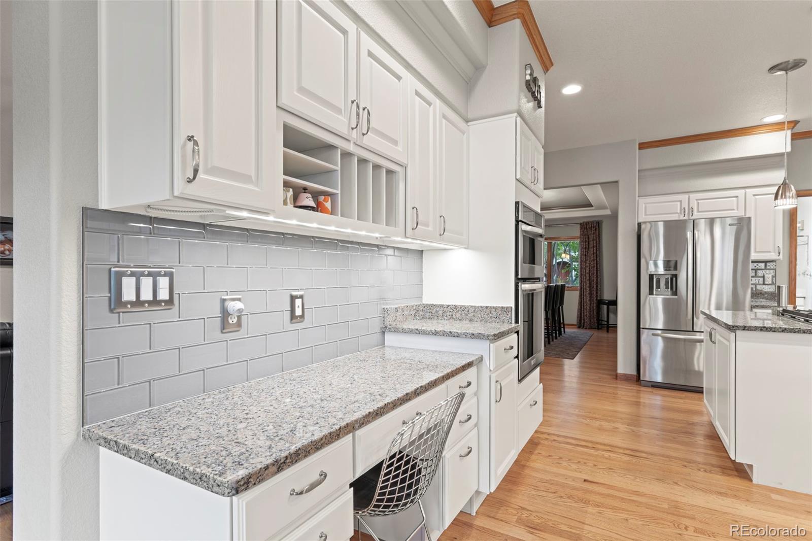 5703 Fig Way Arvada, CO 80002 - Photo 13 of 40 a kitchen with stainless steel appliances granite countertop a sink and dishwasher refrigerator a stove with wooden floor