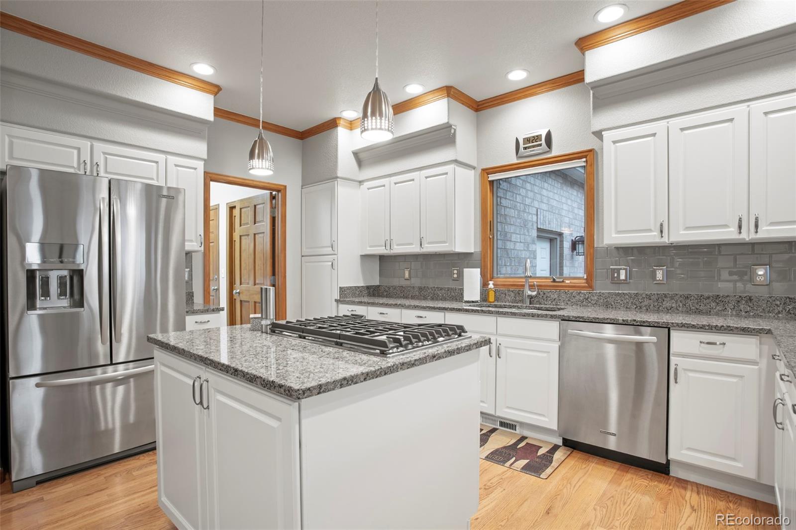5703 Fig Way Arvada, CO 80002 - Photo 9 of 40 a kitchen with stainless steel appliances granite countertop a stove refrigerator sink and cabinets