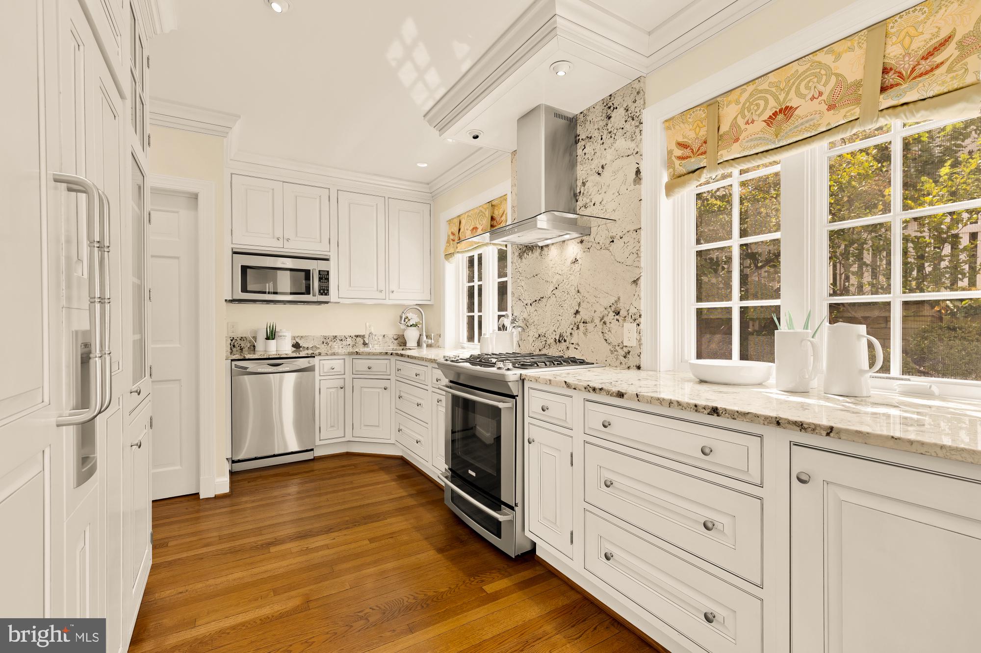 6038 Fort Hunt Road Alexandria, VA 22307 - Photo 20 of 49 a kitchen with granite countertop white cabinets and white appliances