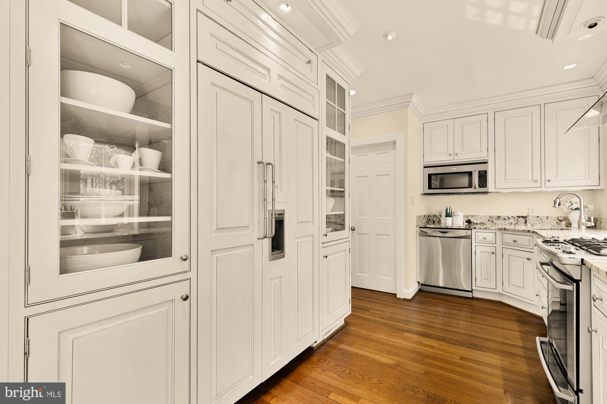 6038 Fort Hunt Road Alexandria, VA 22307 - Photo 21 of 49 a kitchen with stainless steel appliances white cabinets and wooden floors